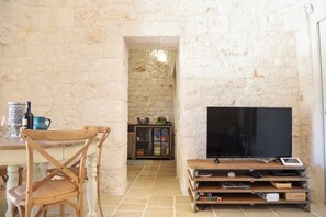 Cozy living space with a dining table, flat-screen TV, and comfortable seating.