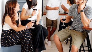 A modern interior with a staircase, a bar area, and people socializing. - GiG Capsule Hostel (Mafra)