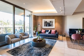 Relax in a well-appointed space with a sofa, armchairs, and a coffee table.