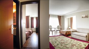 A hotel room with a bed, a desk, a chair, and a sofa. - Seaview Suite Hotel (Kusadasi)