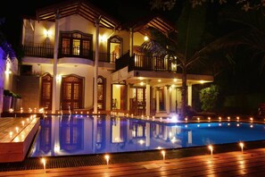 A two-story building with a swimming pool, multiple balconies, and outdoor lighting. - Sandul Villa (Beruwala)