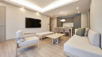 SUITE+(PLUS) | Living area | 65-inch flat-screen TV with cable channels, TV, pay movies