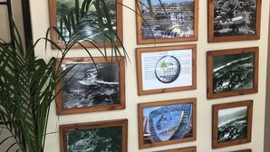 A wall displaying historical photos of Port Edward, including a sign reading "HISTORY ON PORT EDWARD HOLIDAY RESORT". - Port Edward Holiday Resort (Port Edward)