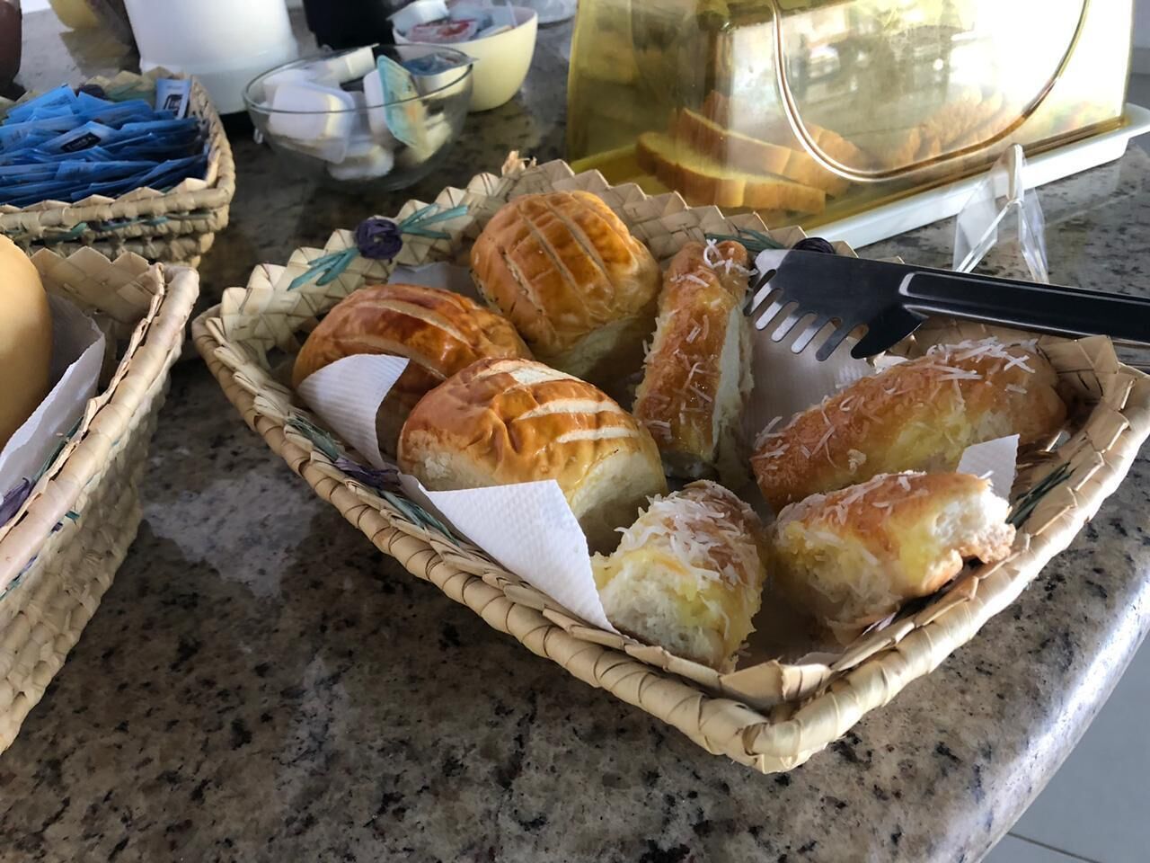 A basket of pastries on a kitchen counter.