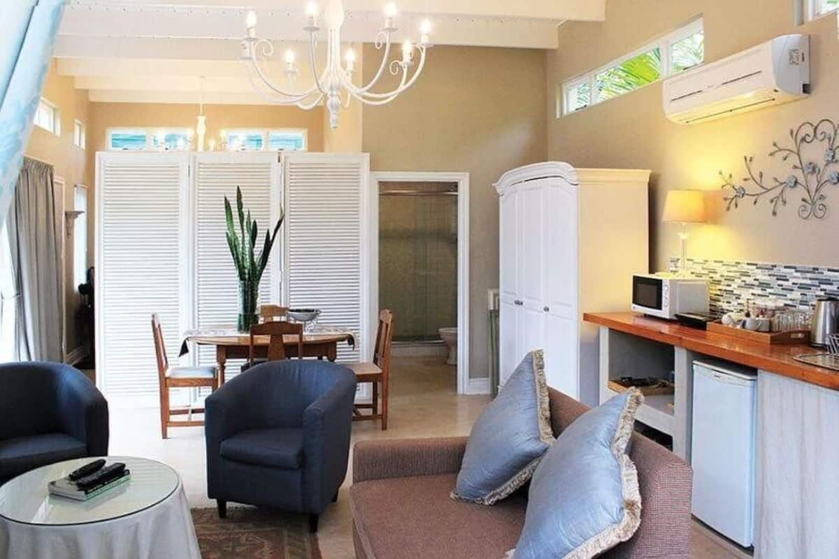 A compact living space with a dining area, kitchenette, and seating area.