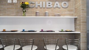 A bar area with a brick wall, a 'CHIBAO' sign, and a row of chairs. - Splendid receptive structure, new construction, anti-seismic. (Ragusa)