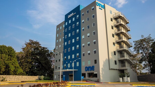 A multi-story hotel with a prominent 'One' branding on the facade.