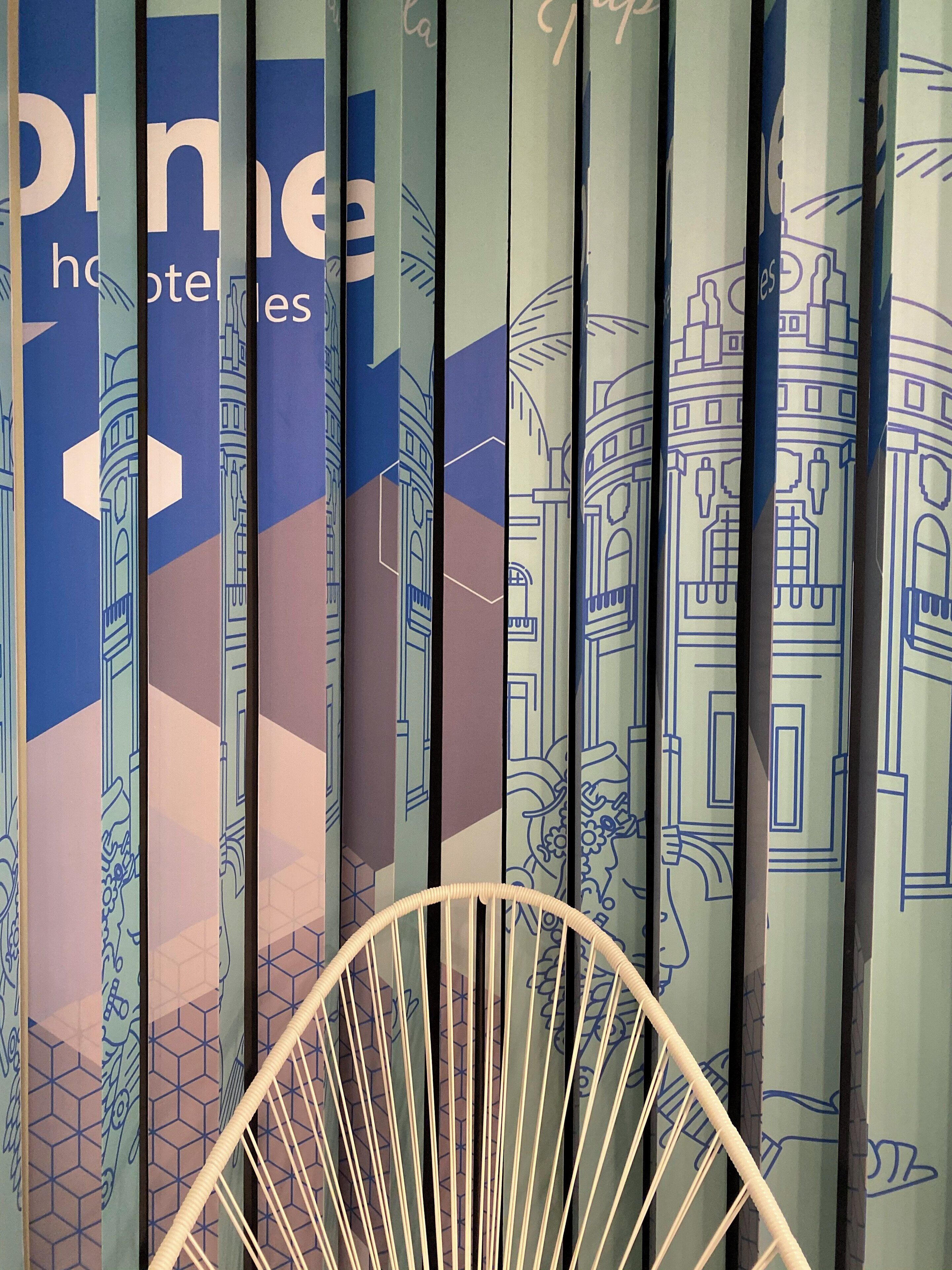 A row of vertical banners with architectural drawings and the text "plume hotels."