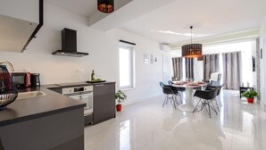 A modern kitchen with a dining area.