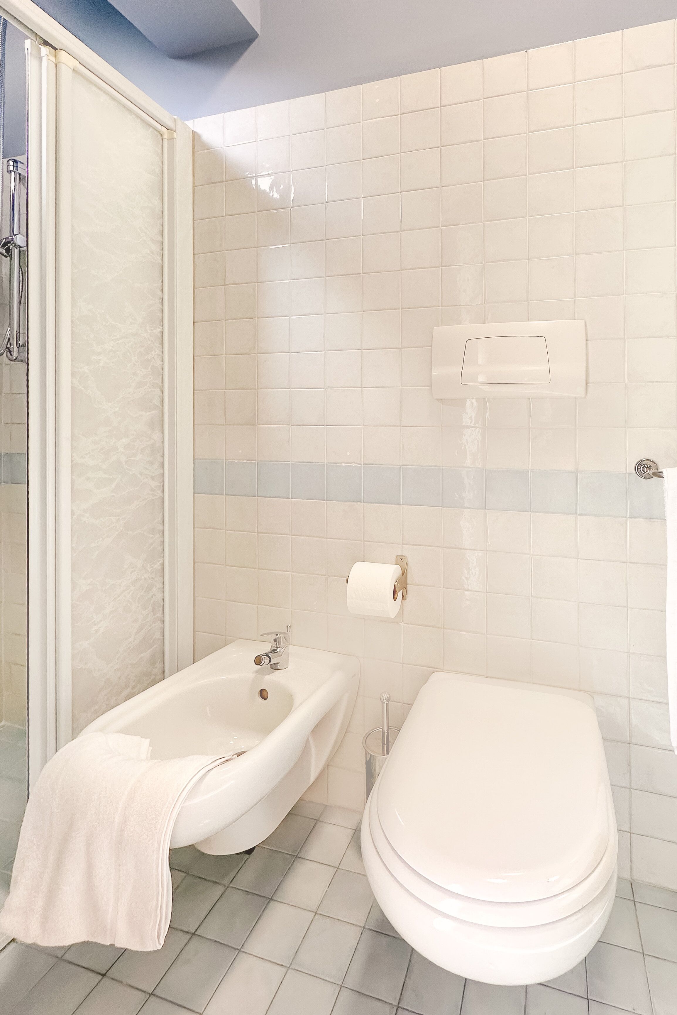 A bathroom with a bathtub, toilet, and a shower area.