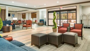 A hotel lobby with seating areas, a reception desk, and large windows. - Comfort Suites DeSoto Dallas South (DeSoto)