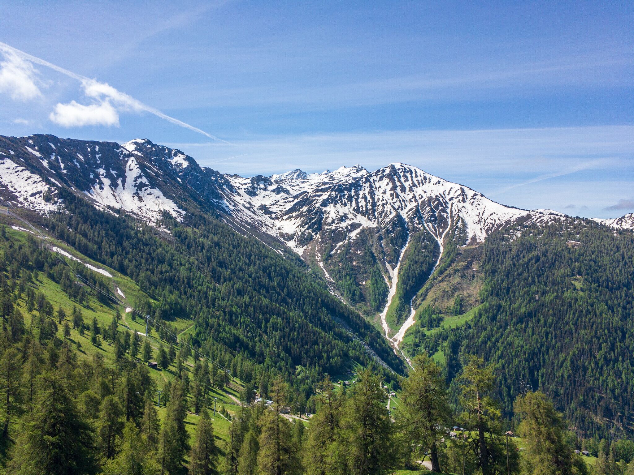 A mountainous landscape with a valley and a river.