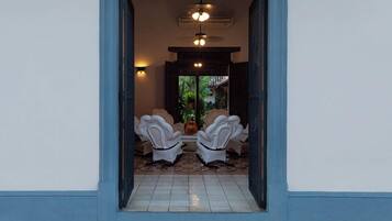 A doorway leading to a room with a tiled floor and a patterned mat.