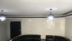 A room with a curved black leather sofa set, two pendant lights, and a door. - Luxury apartment in the heart of Casablanca (Casablanca)