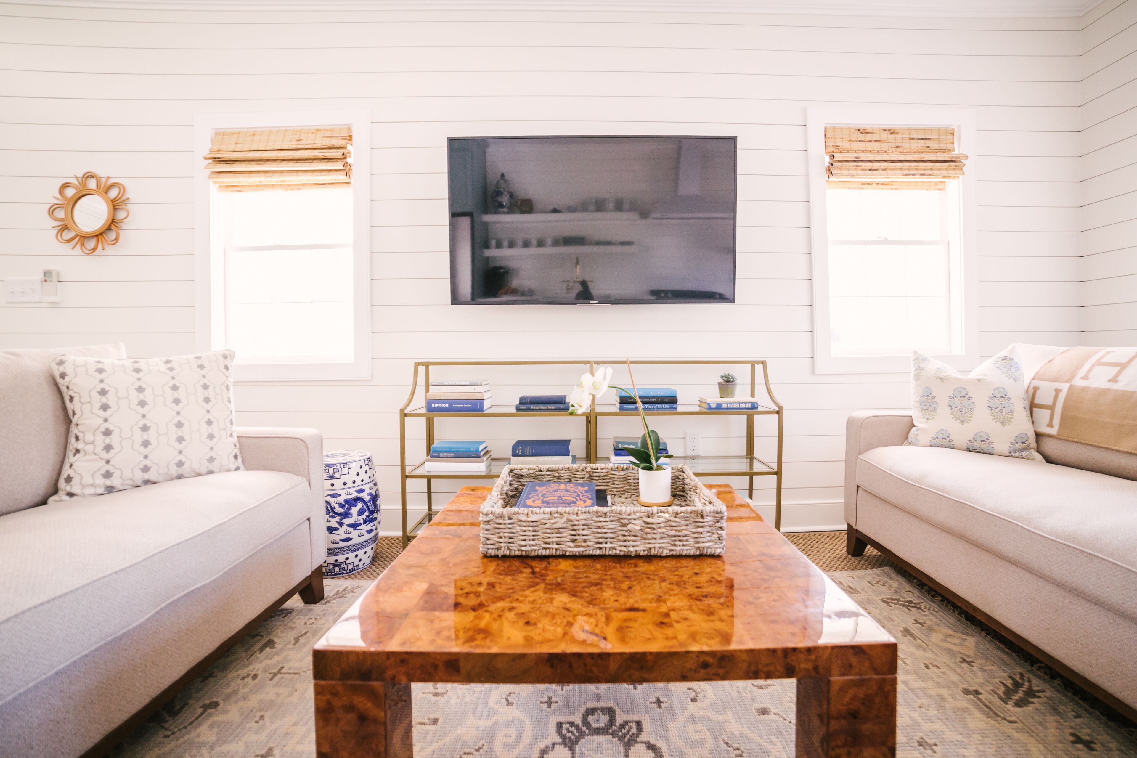 A living room with a white sofa, a coffee table, and a bookshelf.