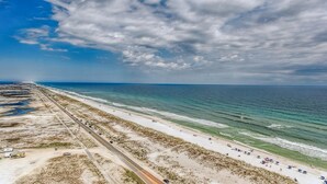 A coastal road with beach access, sandy terrain, and a clear view of the ocean. - Tower 3- Amazing Gulf Views at Portofino 3-1909 (Pensacola Beach)