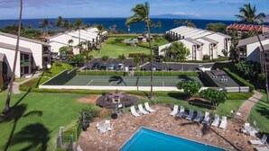 A resort with a pool, tennis court, and ocean view. - Maui Beach Front Condo Walking Distance to Beaches and Restaurants, ocean views (Kihei)