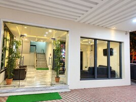 A modern interior with a staircase, a sofa, and a television.