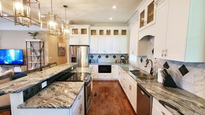 Enjoy cooking in this well-lit kitchen with a central island and ample counter space.