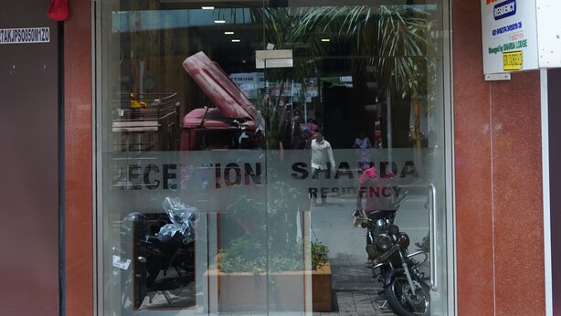 A Sharda Residency building with a reception area visible through the glass doors. - Sharda residency (Mumbai)