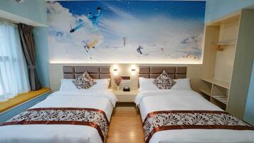 A hotel room with two beds, a large mural of a snowy landscape, and a wooden floor.