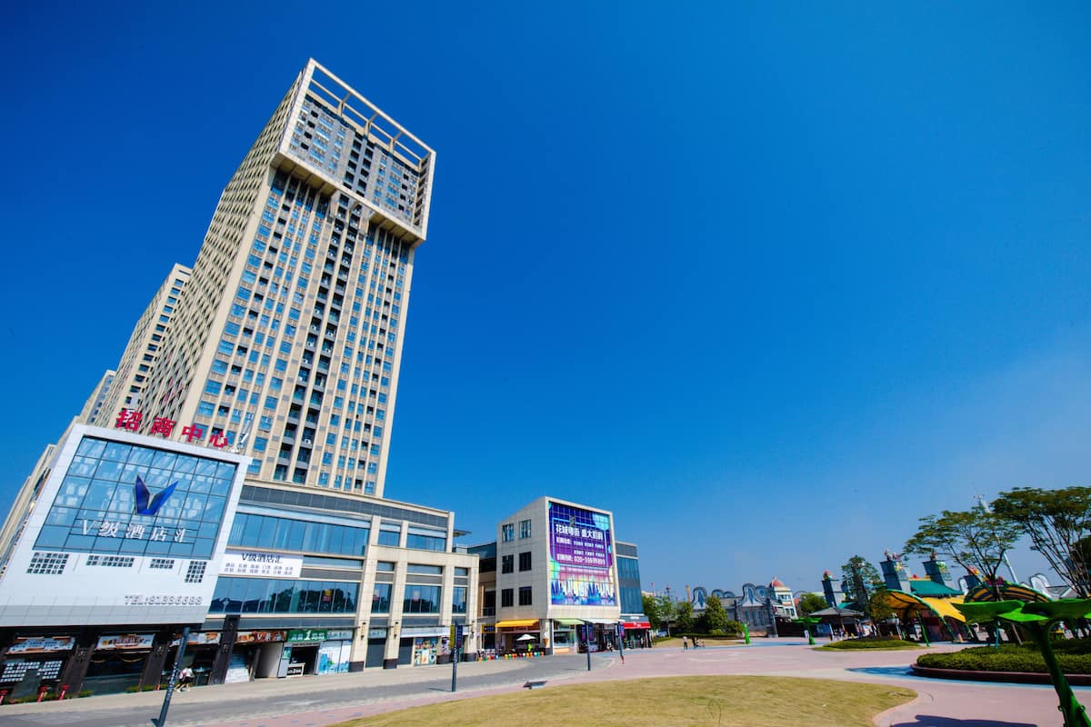 A modern high-rise building with multiple floors and a prominent glass facade.