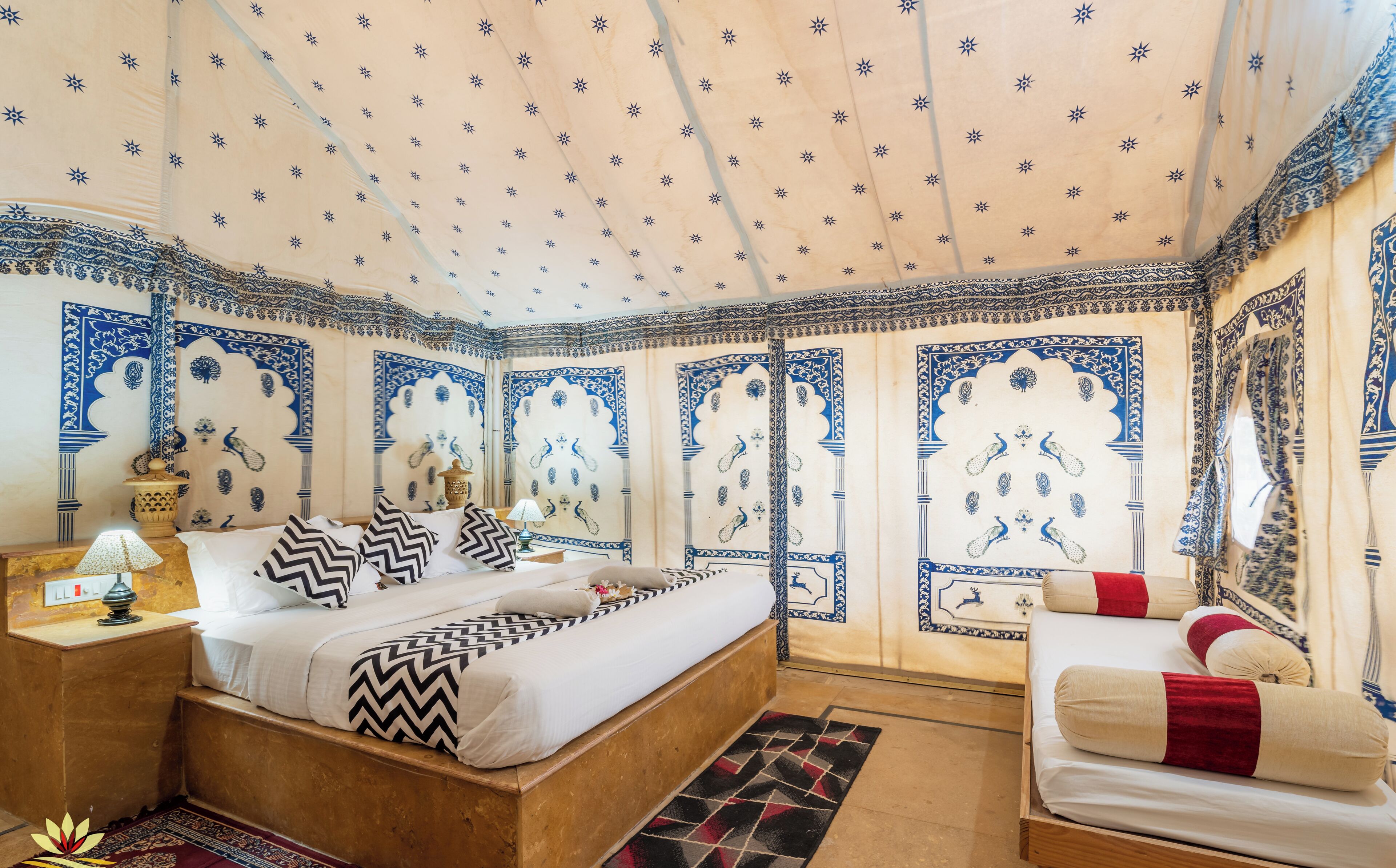 A traditional room with a bed, a nightstand, a lamp, and a chair.