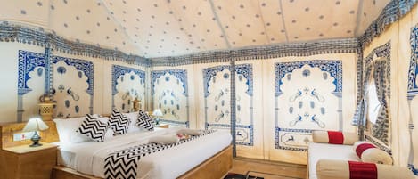 A traditional room with a bed, a nightstand, a lamp, and a chair.