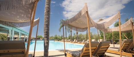 Seasonal outdoor pool, open 11:00 AM to 7:00 PM, pool loungers