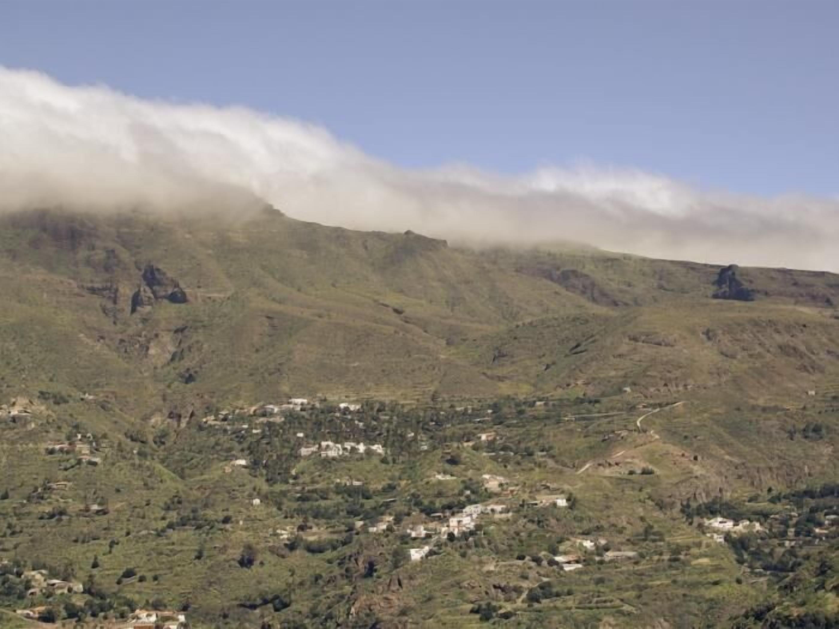 A mountainous landscape with a small village nestled among the hills.