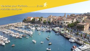 A marina filled with various boats and yachts, surrounded by buildings and a clear sky.