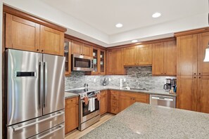 Enjoy cooking in this well-equipped kitchen with a double-door refrigerator, microwave, oven, and dishwasher.