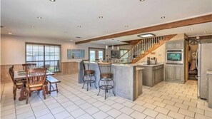 Enjoy meals at the central island or dining table for four, surrounded by ample kitchen space.