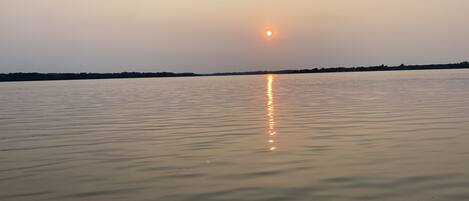 A calm body of water reflecting the sun.