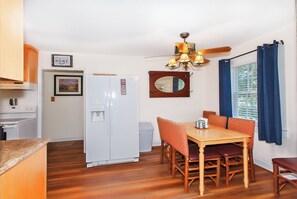 Enjoy meals in the kitchen with a stove, sink, and dining table for four.