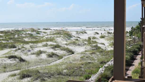 A beach view with sand dunes, a pathway, and a wooden structure. - Gorgeous 2 bed 2 bath beachfront condo (North Myrtle Beach)