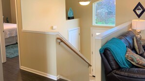 A staircase leading to a bedroom with a view of trees through a window. - Beautiful Spokane Valley Home (Spokane Valley)