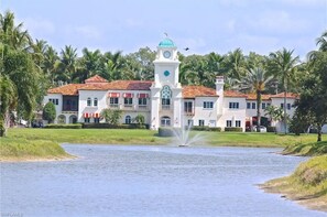A large, white building with a clock tower and a fountain in front. - Luxury Villa in Village Walk North Naples Check availability for season 2026/27 (Naples)