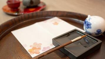 A tray with a tea set, including a teapot, cups, and a brush.