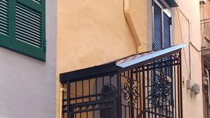 A staircase with a wrought iron gate leading to an upper floor.