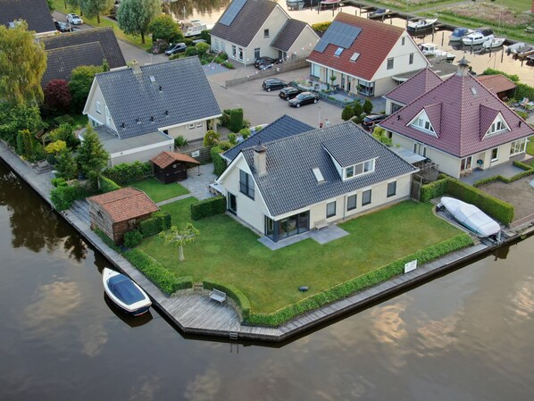 A residential area with houses, a dock, and a boat.