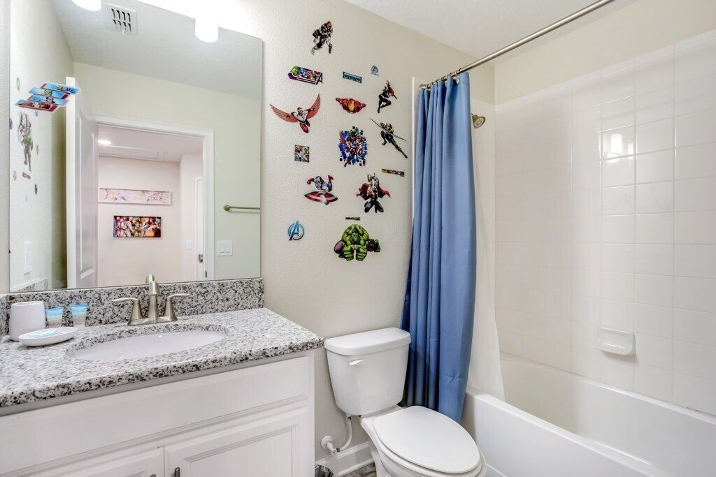 A bathroom with a white sink, toilet, and bathtub.