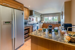 A modern kitchen with a built-in refrigerator, stove, and microwave. - 3 Bed in Lynton (oc-keepba) (Ilkerton)