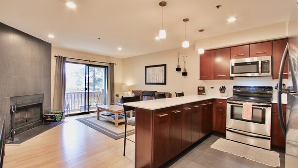 A modern kitchen with wooden cabinets, stainless steel appliances, and a large island. - Spacious and Beautiful, Walk to ski, Wi-fi, Parking (Park City)