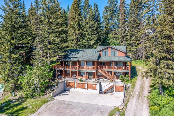 Escape to a serene forest retreat with a spacious balcony and an entrance.