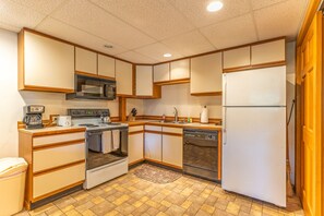 Enjoy cooking in this well-equipped kitchen with a microwave, stove, oven, dishwasher, and refrigerator.