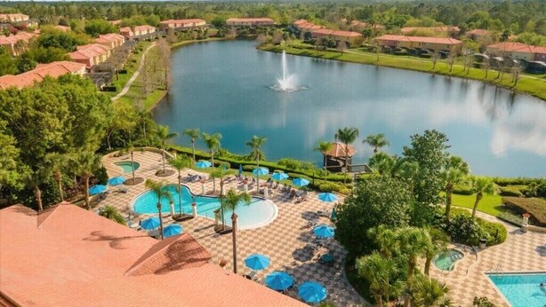 A resort with a large lake, multiple swimming pools, and a well-maintained landscape. - 3 Bedrooms / 2.5 Bathrooms / Encantada (3091 YL) (Kissimmee)