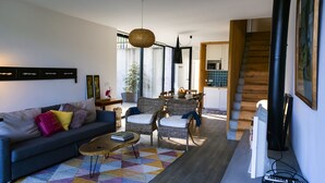 A modern living room with a sofa, chairs, a coffee table, and a colorful rug. - FURNAS HOUSES South (19A) (FURNAS)