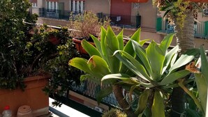 A residential building with multiple balconies, some with plants and outdoor furniture. - Ariston (Palermo)