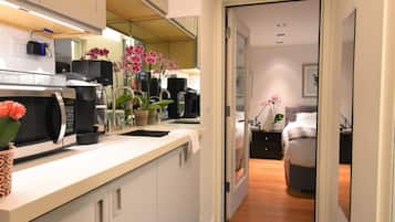 Fridge, microwave, coffee/tea maker, cookware/dishes/utensils